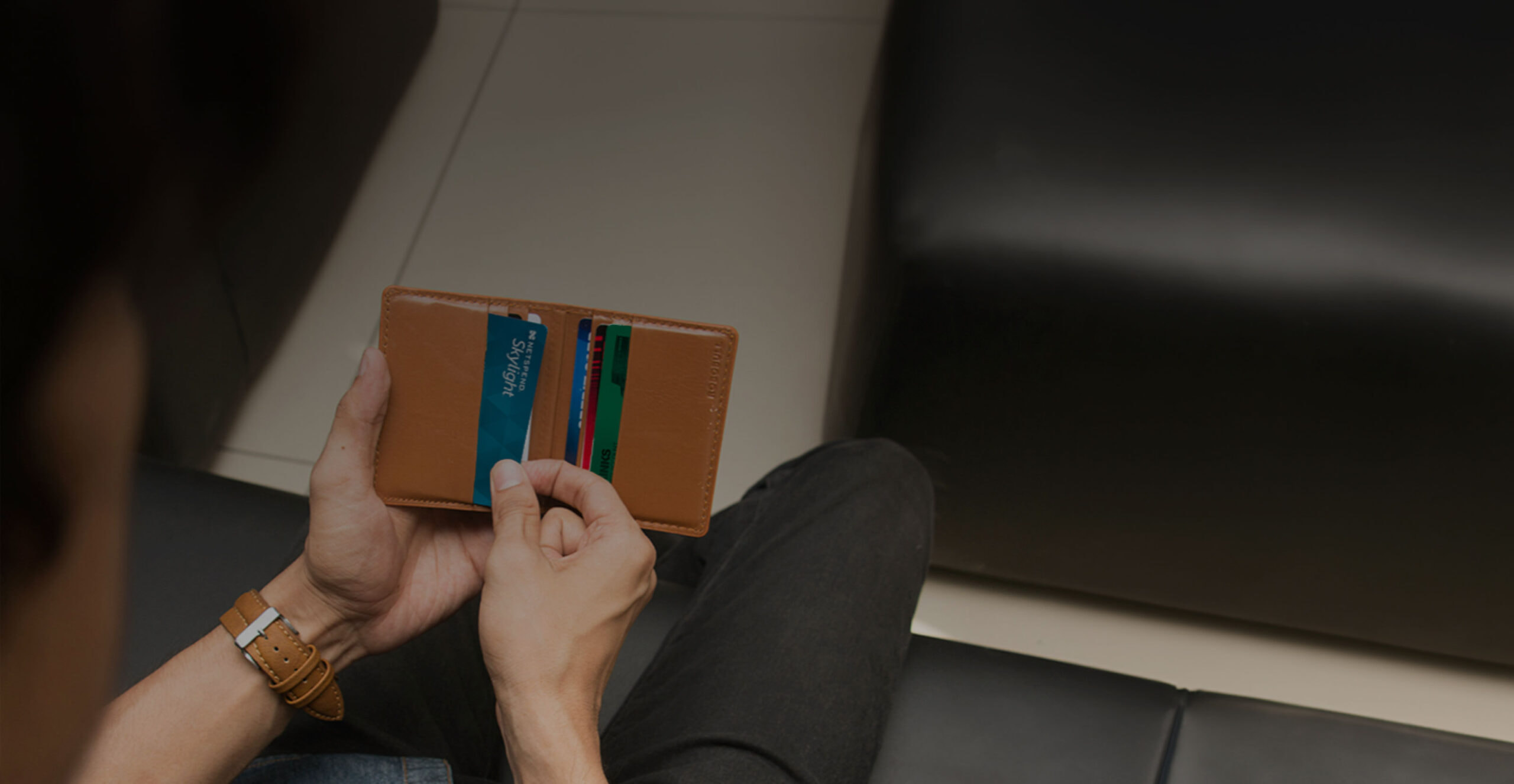 Netspend card being pulled out of a wallet