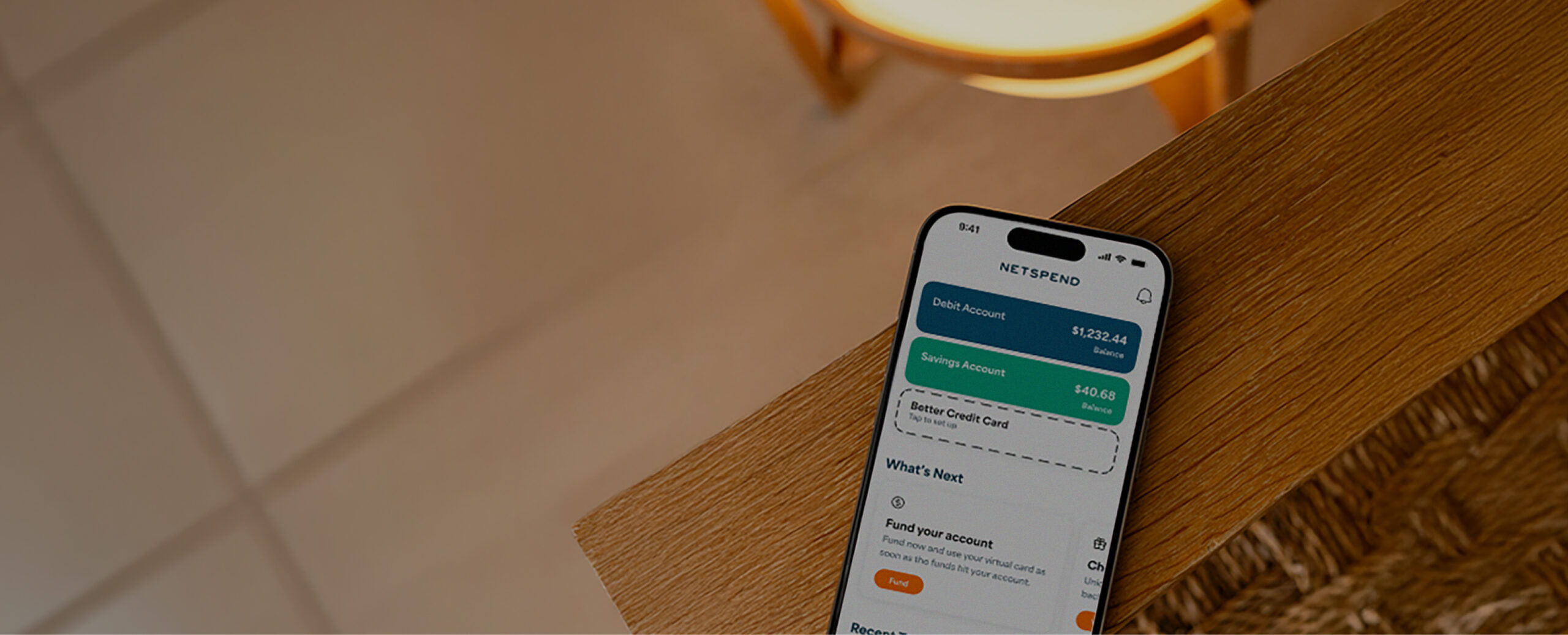 IPhone on a table displaying the Netspend Wallet App